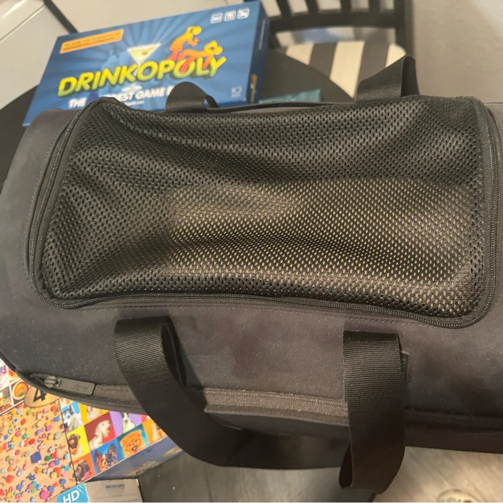 Small dog carrier. a little bed inside. Never used. Two openings. 2 sidezippers